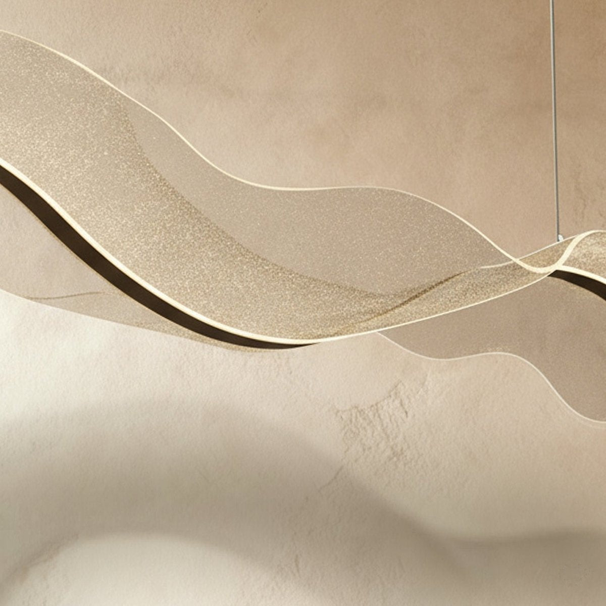 This close view of the Clérachic wave chandelier reveals a fine speckled, starry-sky-like texture.