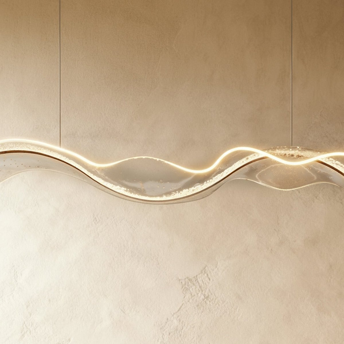 Close-up of the lit Clérachic chandelier shows a dimpled, water-ripple texture along its LED edge.