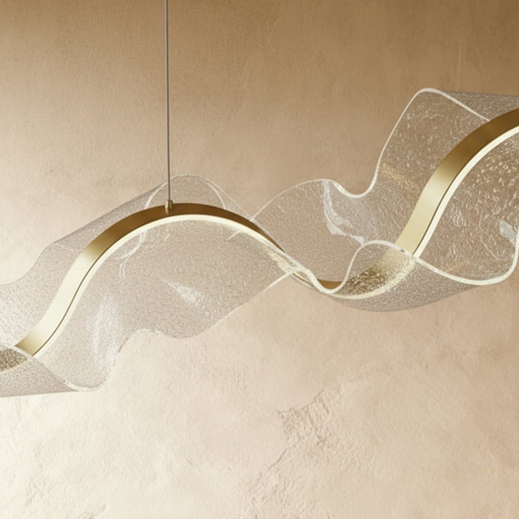 This close view of the Clérachic chandelier's clear acrylic shows bubbled dot texture over brass trim.