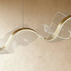 This close view of the Clérachic chandelier's clear acrylic shows bubbled dot texture over brass trim.