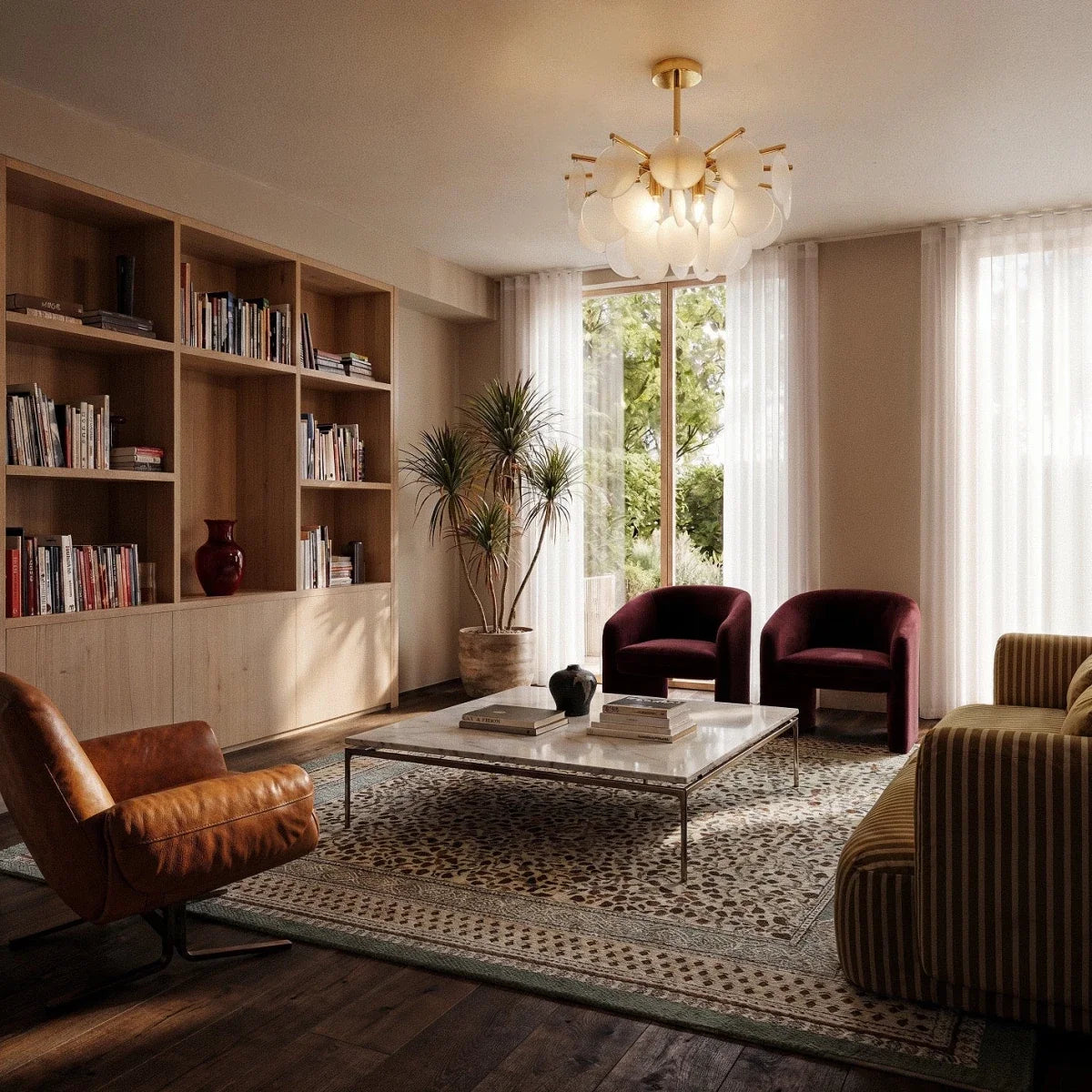 Clérachic Isla chandelier in translucent glass lit warm above a living room with bookshelves and burgundy chairs.