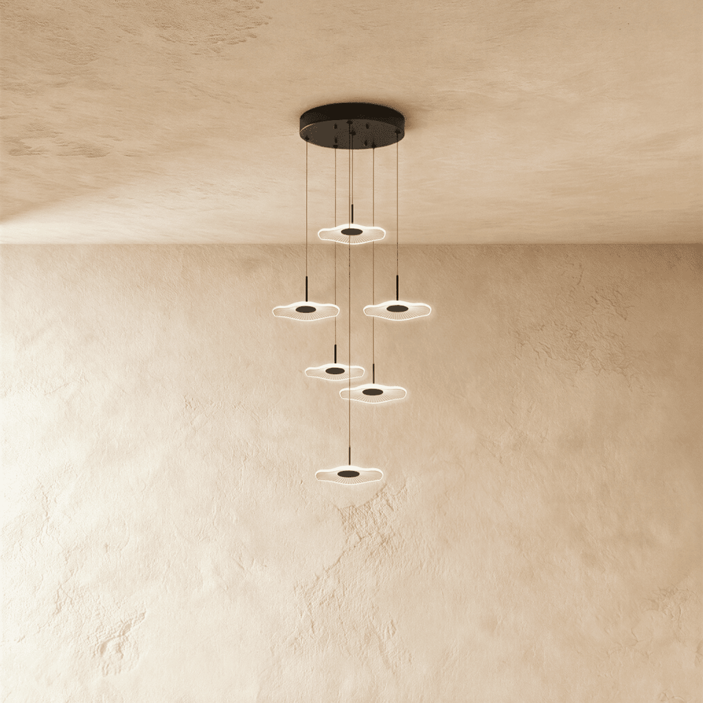 Clérachic staircase chandelier in black, six glowing flower-shaped discs spiralling down at staggered heights.