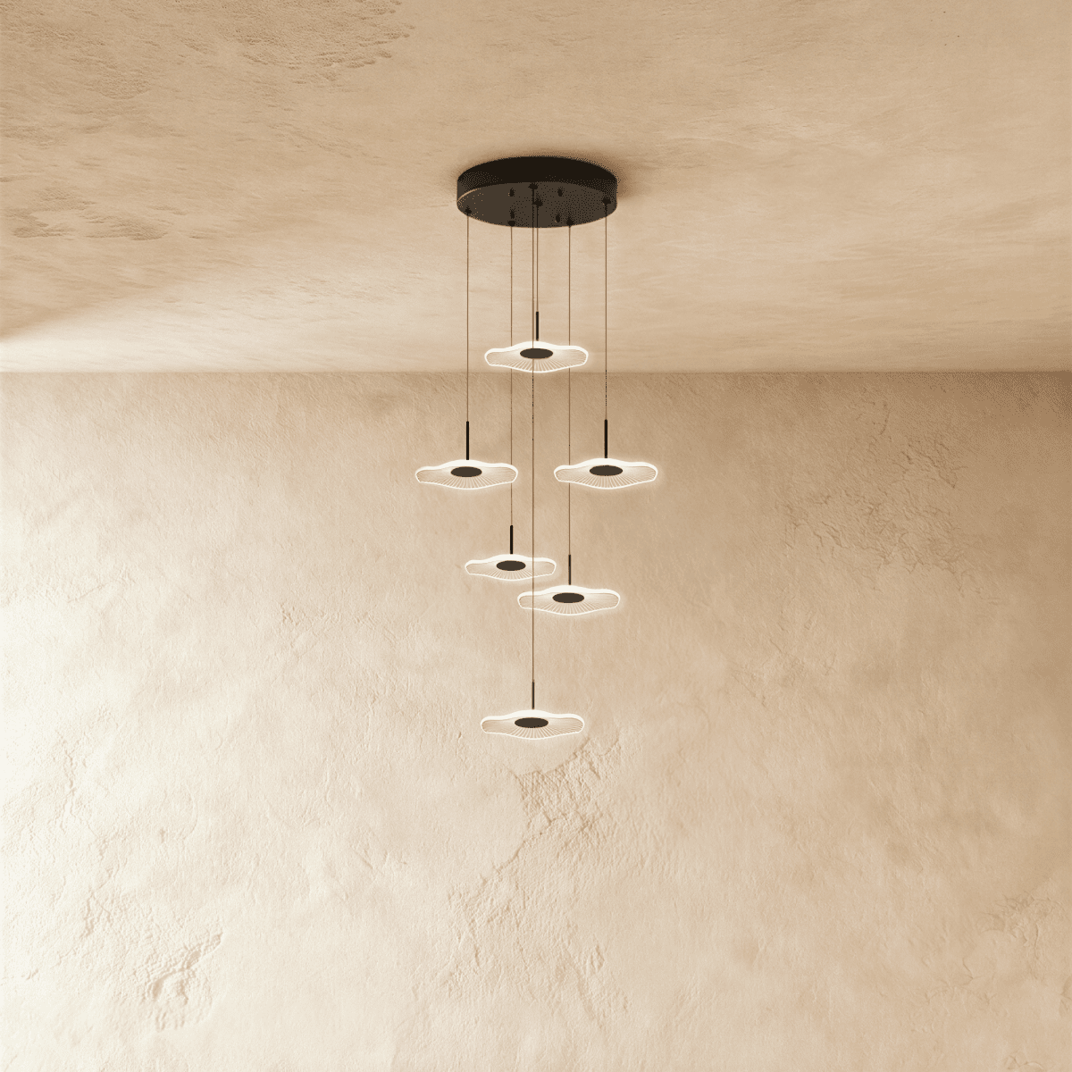Clérachic staircase chandelier in black, six glowing flower-shaped discs spiralling down at staggered heights.