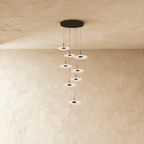 Clérachic staircase chandelier in black, its cascading flower-shaped discs viewed from a slightly different angle.