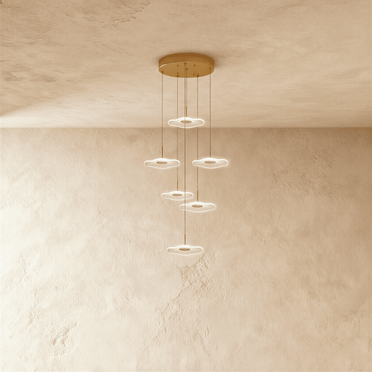 Clérachic staircase chandelier in gold, six glowing flower-shaped discs spiralling down at staggered heights.