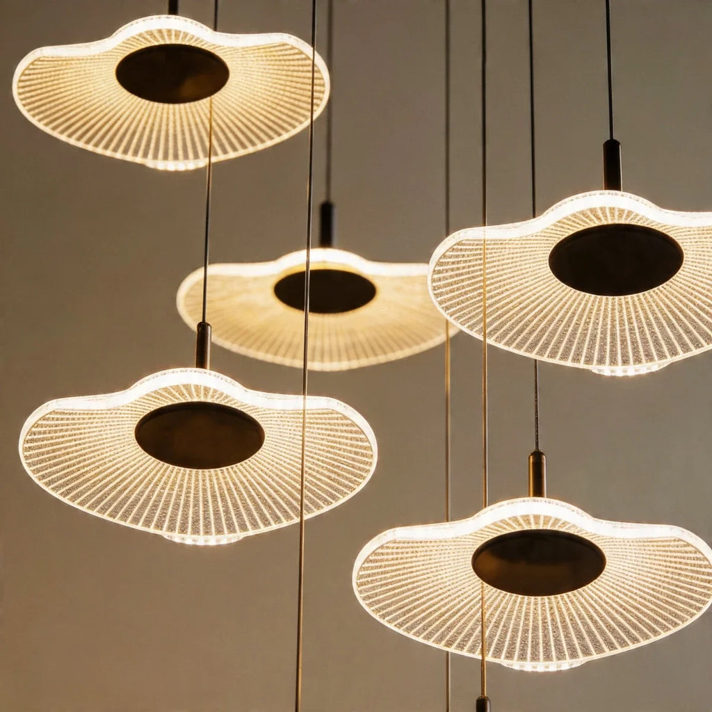 Close-up of the Clérachic staircase chandelier's ribbed flower-shaped discs, each glowing warm white at its centre.
