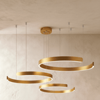 Clérachic's three-ring LED chandelier hangs in a warm gold finish, its rings staggered from small to large.