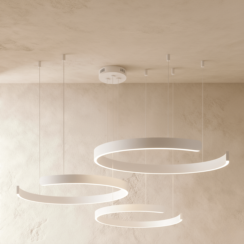 This Clérachic three-ring LED chandelier hangs in matte white, its rings staggered from small to large.