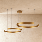 Clérachic's two-ring LED chandelier hangs in warm gold, its stacked rings glowing softly from below.