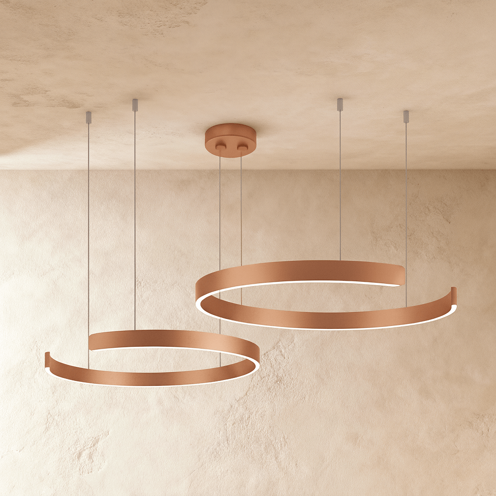 This Clérachic two-ring chandelier hangs in a rose gold finish, its two round rings staggered in height.