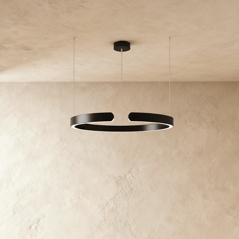 A single Clérachic LED ring chandelier hangs in matte black, its round profile glowing evenly from below.