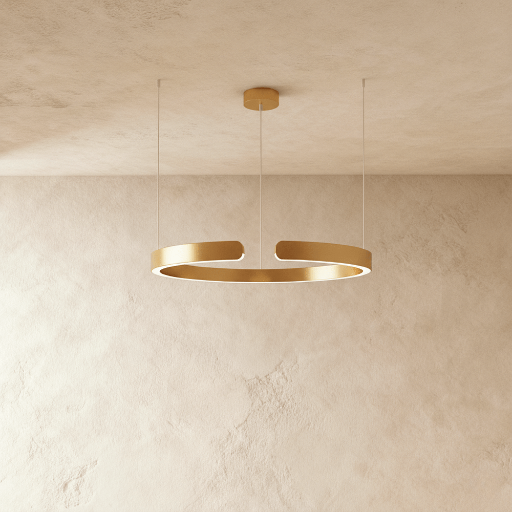 A single Clérachic LED ring chandelier hangs in warm gold, its round profile glowing evenly from below.