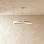 A single Clérachic LED ring chandelier hangs in matte white, its round profile glowing evenly from below.