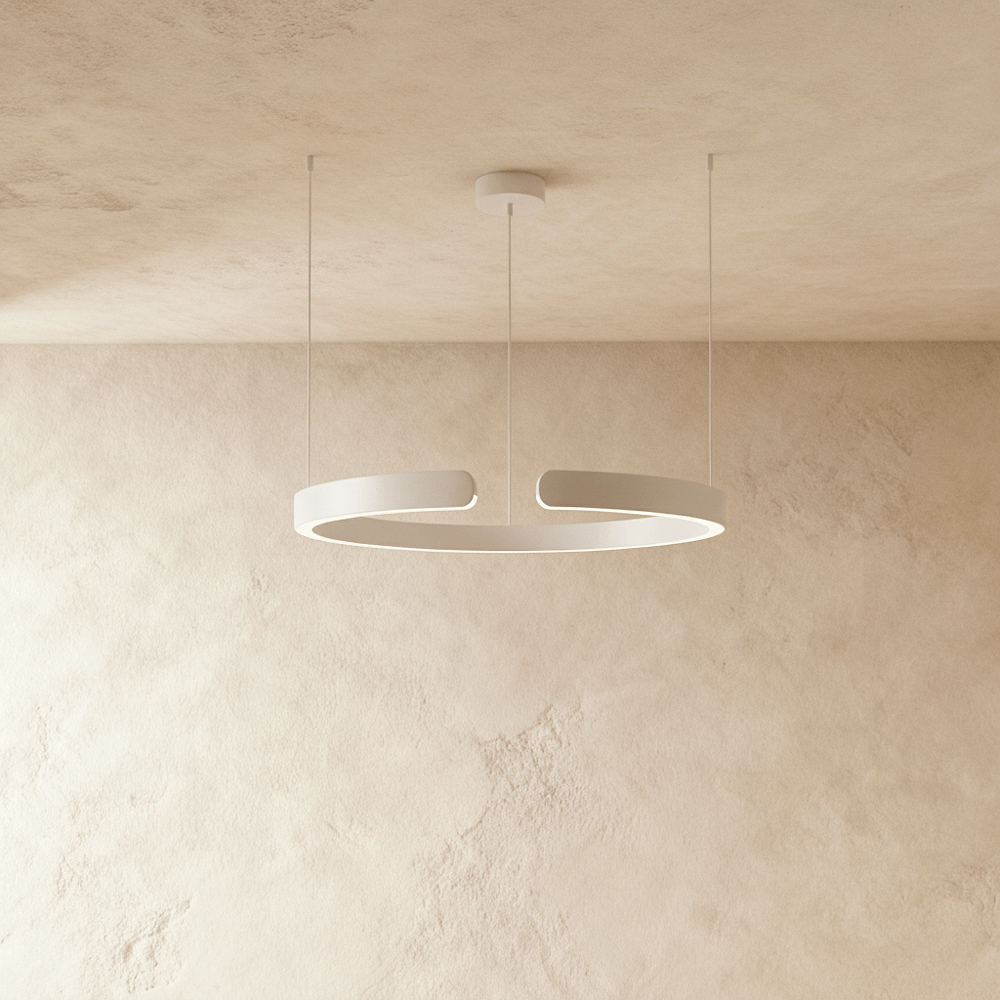 A single Clérachic LED ring chandelier hangs in matte white, its round profile glowing evenly from below.