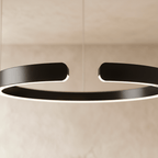 A close view of the Clérachic ring chandelier's matte black finish shows the gap where its ends meet.