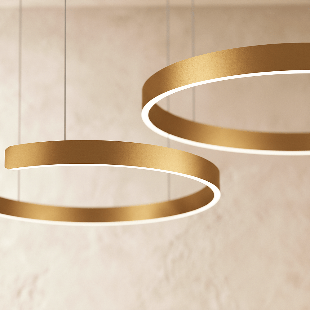 A close view of the Clérachic ring chandelier's warm gold finish shows two stacked rings glowing softly.