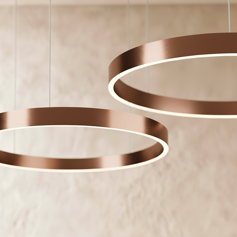 A close view of the Clérachic ring chandelier's rose gold finish shows two stacked rings glowing softly.