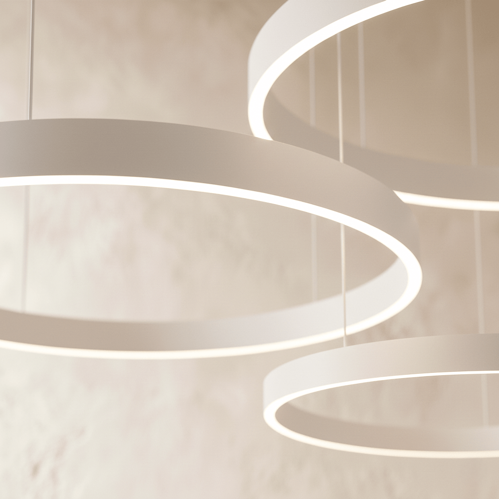 A close view of the Clérachic ring chandelier's pale finish shows its stacked rings glowing from below.
