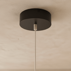 The Clérachic ring chandelier's matte black ceiling canopy holds a single suspension cable and LED wire.