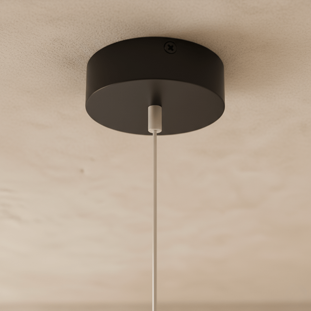 The Clérachic ring chandelier's matte black ceiling canopy holds a single suspension cable and LED wire.