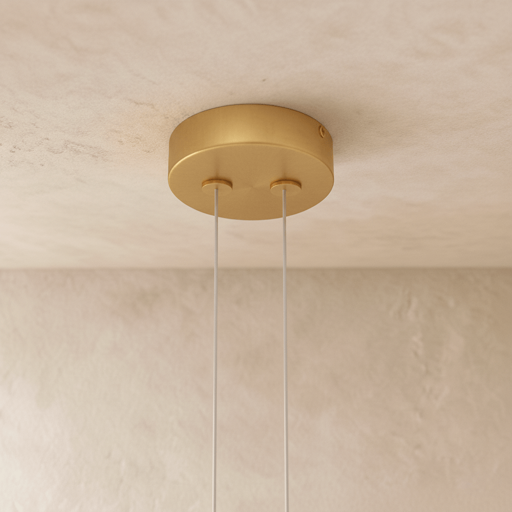 The Clérachic ring chandelier's warm gold ceiling canopy holds two suspension cables for its stacked rings.