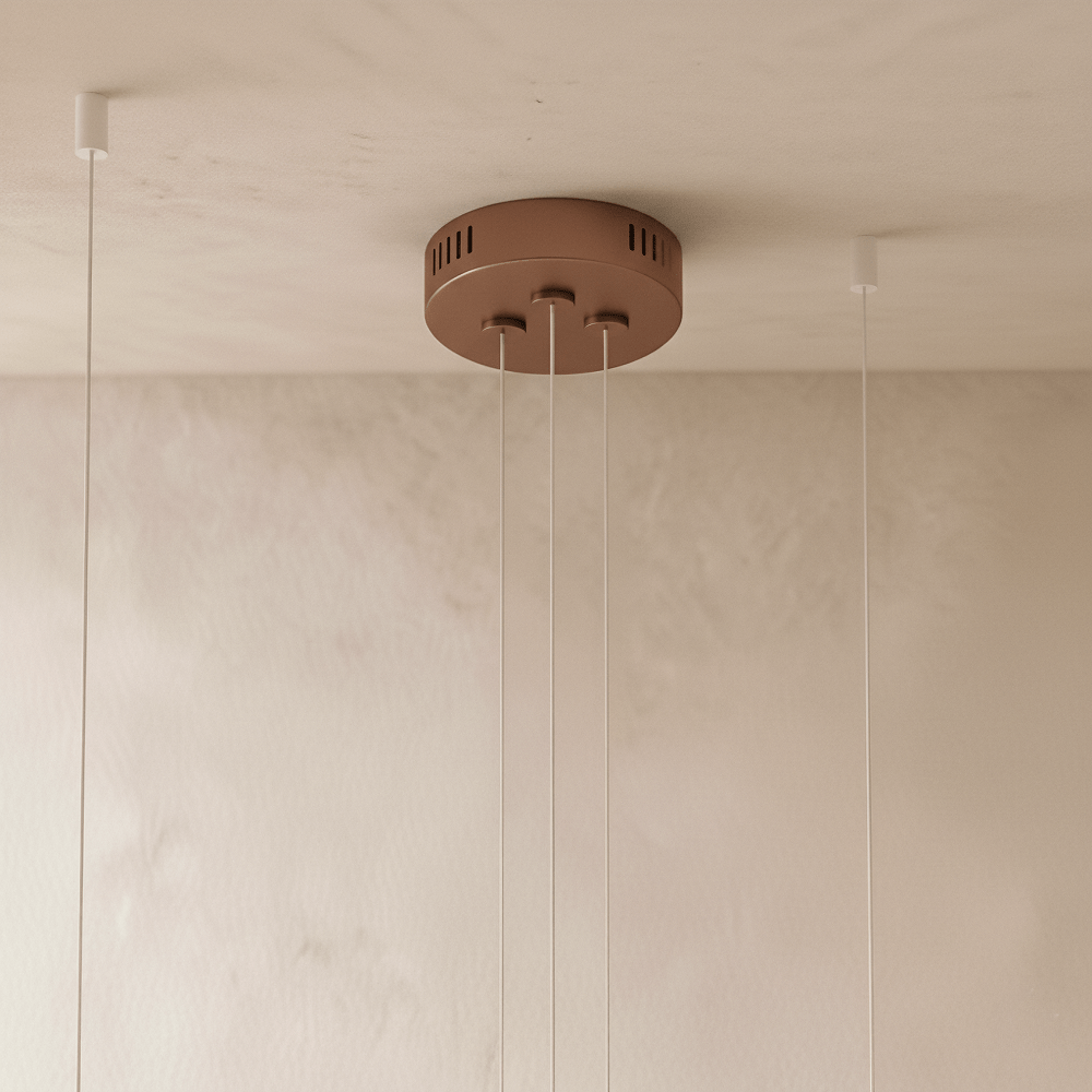 The Clérachic three-ring chandelier's rose gold canopy holds three cables with vents for the LED driver.