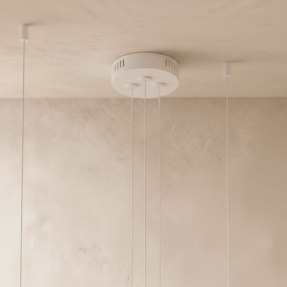 The Clérachic three-ring chandelier's matte white canopy holds three cables with vents for the LED driver.