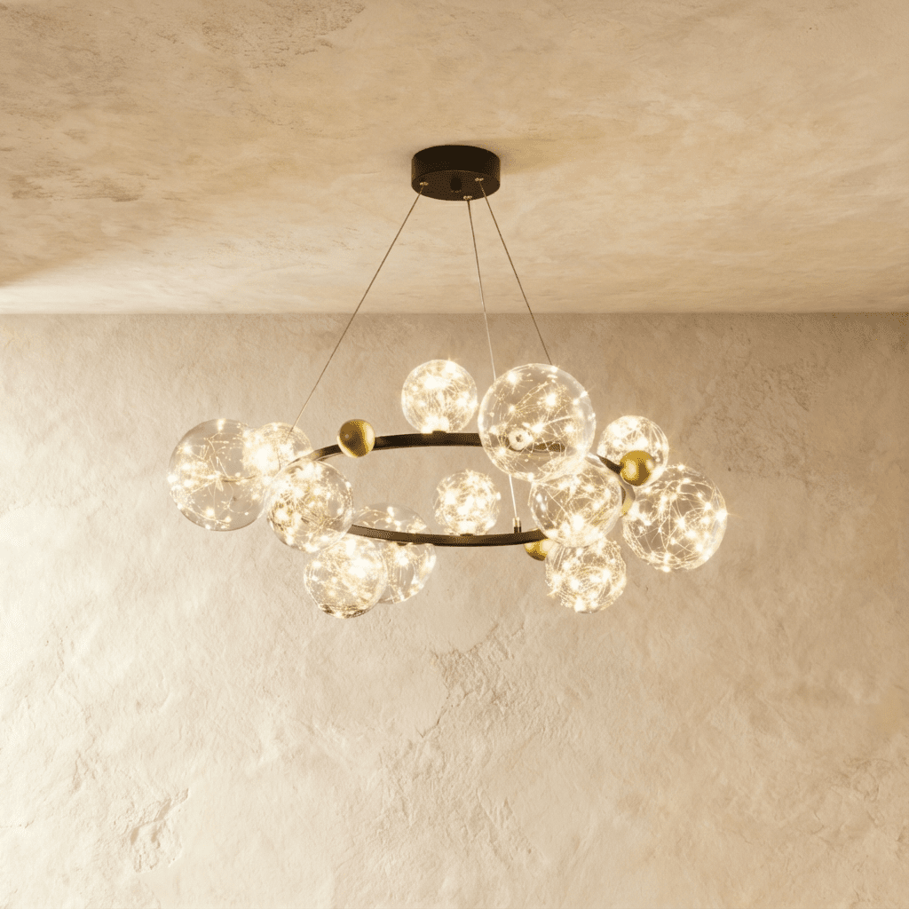 Clérachic chandelier in black, its ring of glass bubble globes glowing warm white beneath a plaster ceiling.