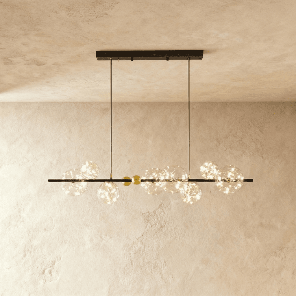 Clérachic chandelier in black, a linear bar strung with glowing glass bubble globes along its length.