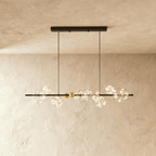 Clérachic chandelier in black, a linear bar strung with glowing glass bubble globes along its length.