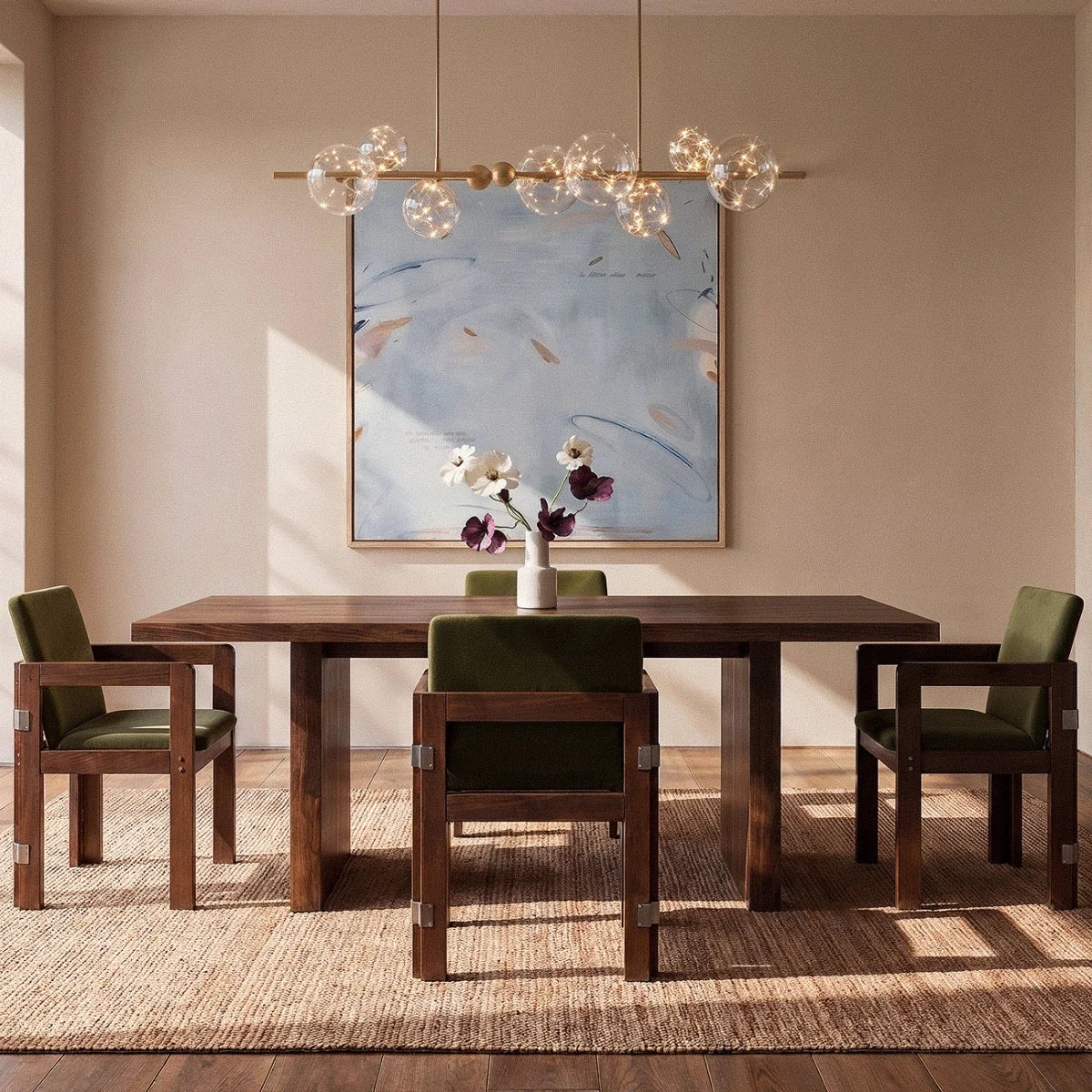 Clérachic chandelier in gold hung over a dining table, its glass globes glowing warm beneath framed art.