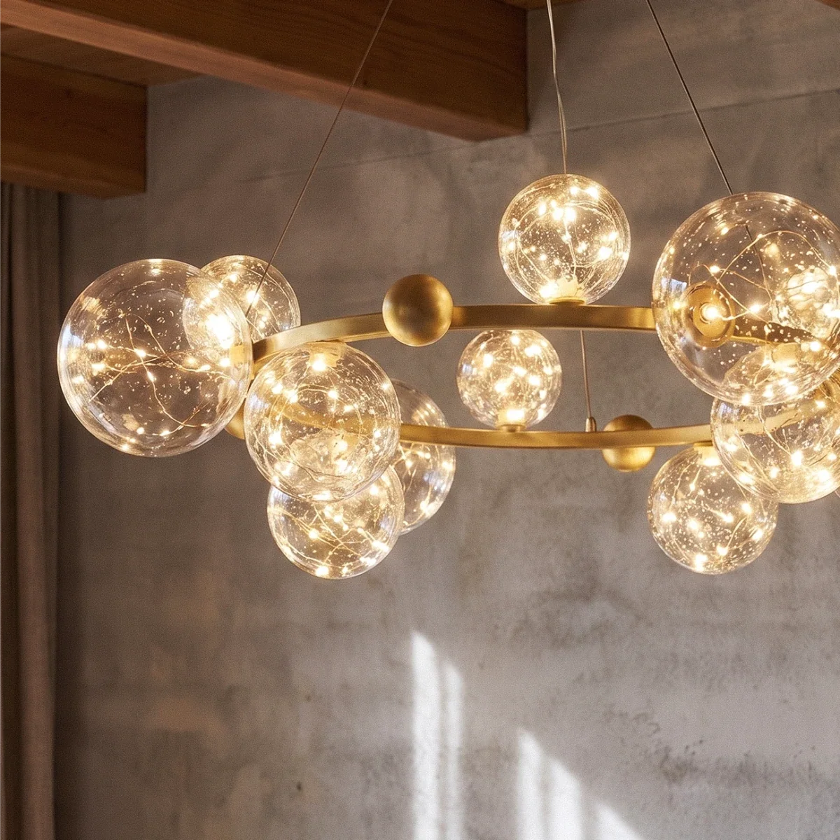 Close-up of the Clérachic chandelier's ring of glass globes, glowing warm white against a concrete wall.