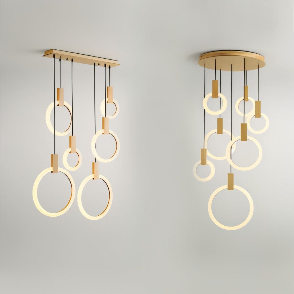 Clérachic long five-ring and round seven-ring versions of the lit acrylic and gold-toned ring pendant, side by side.