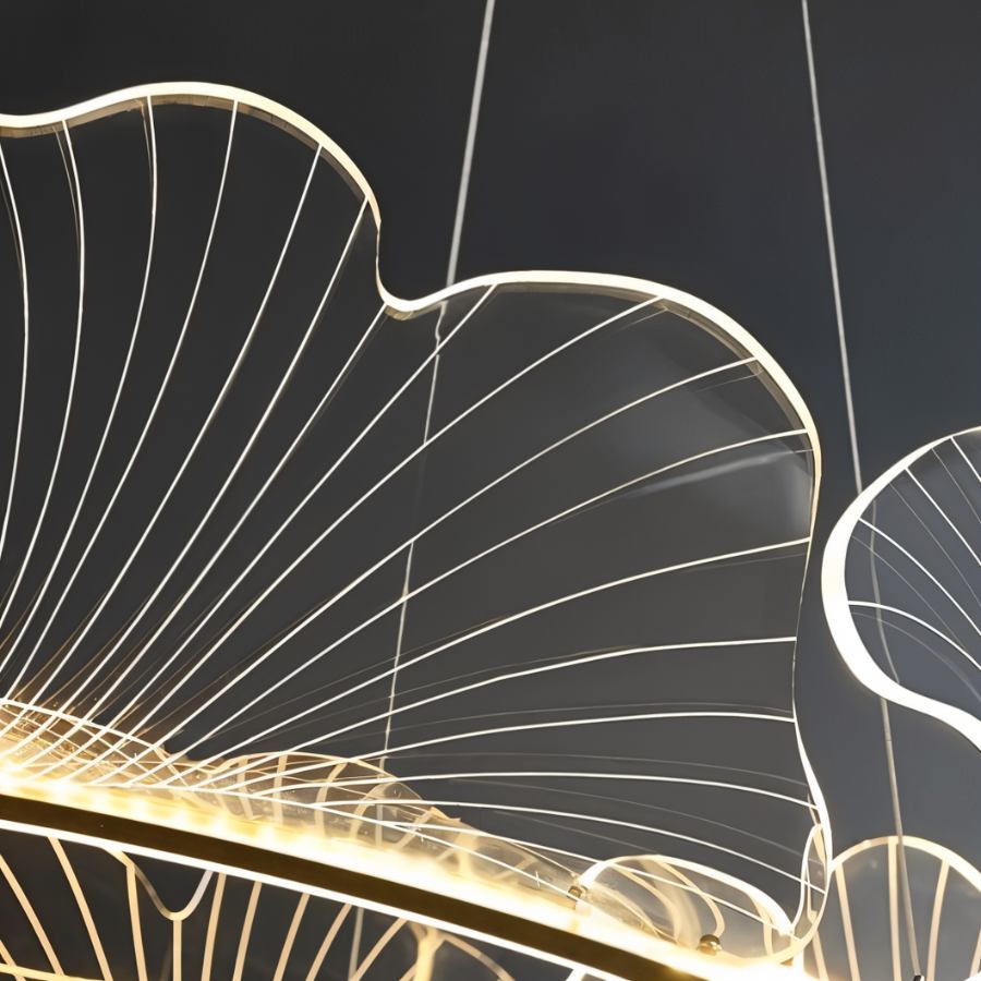 Clérachic close view of a clear acrylic leaf shade, its fine engraved veins glowing along the edge above a gold ring.