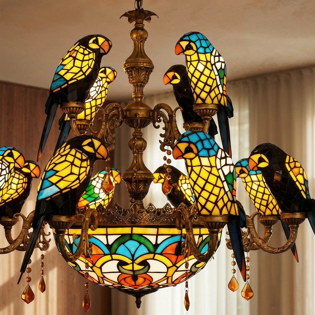 Close view of the Clérachic chandelier's glass parrots in blue, yellow and black, with gilt-brass arms and amber crystal drops.