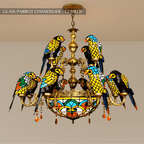 Clérachic two-tier chandelier of twelve glass parrots on gilt-brass arms, amber crystal drops below, hung on a chain.