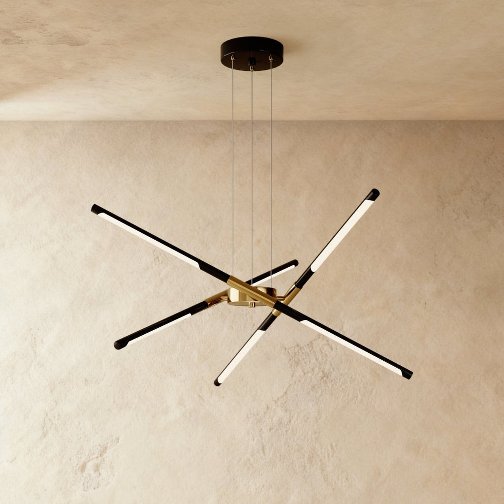 Clérachic six-rod chandelier in black and gold, rods angled outward from a gold hub beneath a round black ceiling plate.