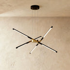 Clérachic six-rod chandelier in black and gold, rods angled outward from a gold hub beneath a round black ceiling plate.