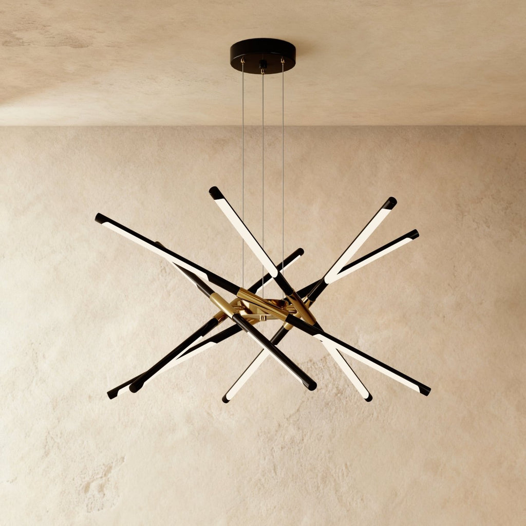 Clérachic twelve-rod starburst chandelier in black and gold, a dense burst of slim LED rods on three suspension cables.