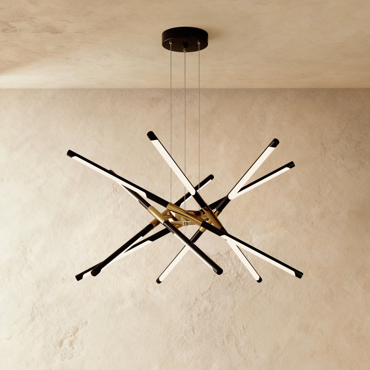 Clérachic twelve-rod starburst chandelier in black and gold, a dense burst of slim LED rods on three suspension cables.
