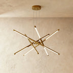 Clérachic ten-rod starburst chandelier in all-gold, slim LED rods crossing at varied angles from a central hub.