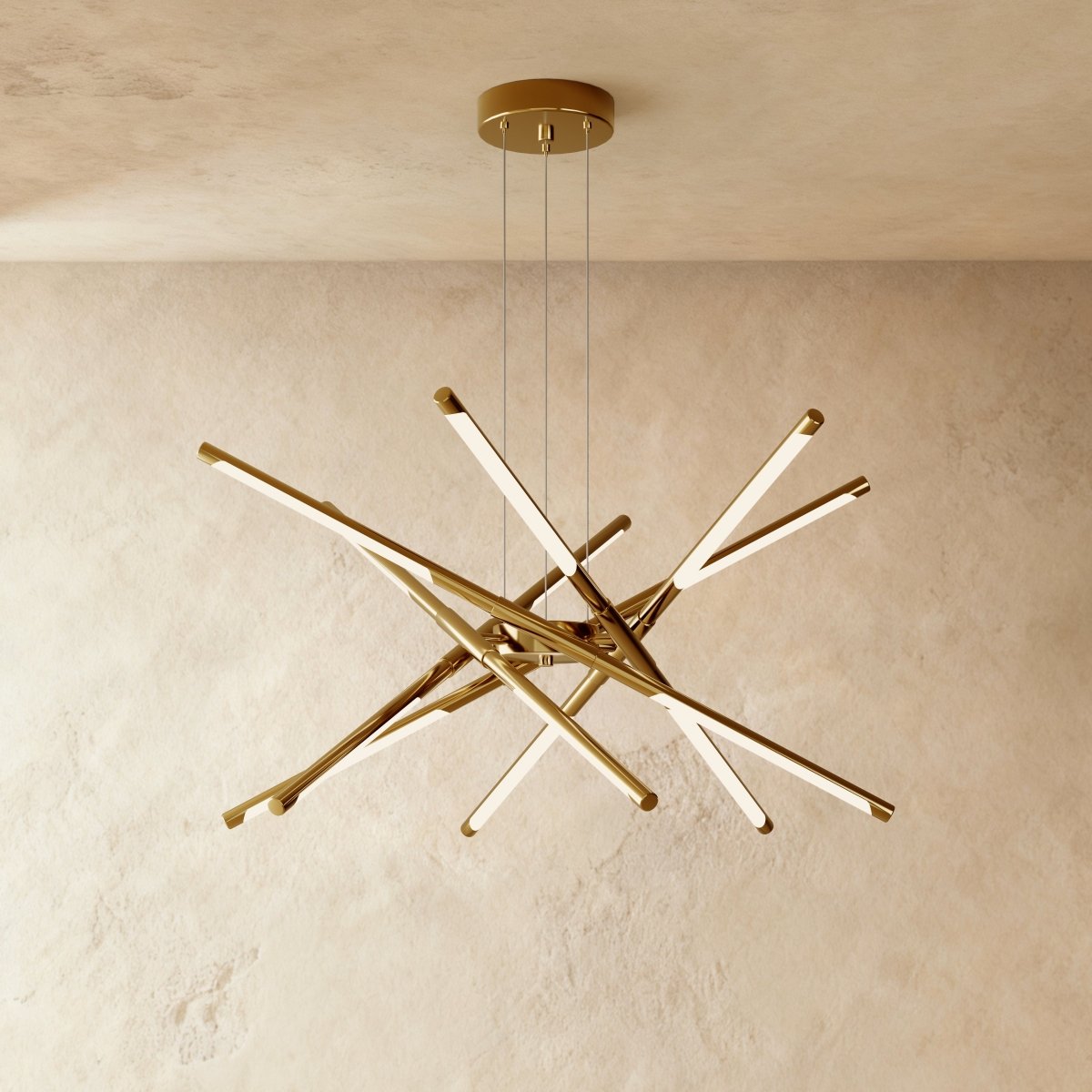 Clérachic twelve-rod starburst chandelier in all-gold, a dense burst of slim LED rods hung from three cables.