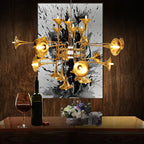 Gold Clérachic chandelier with trumpet heads against a dark wood wall and a black-and-white painting, above a table with wine.