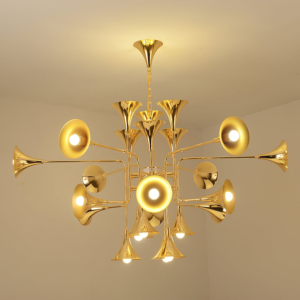 A glowing gold Clérachic chandelier seen from below in a corner of a warm cream room, with light spilling onto the ceiling.