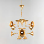 Gold trumpet-head Clérachic chandelier hanging from a chain and ceiling horn, photographed on a pale grey backdrop.