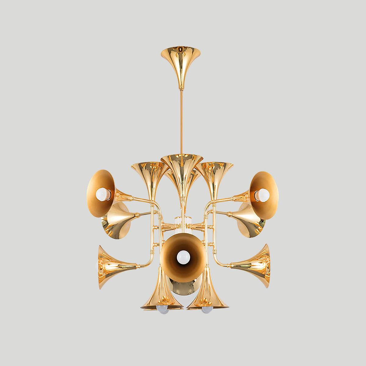 Smaller gold trumpet-head Clérachic chandelier on a plain light grey backdrop, hanging from a straight stem.