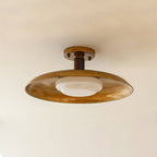 A Clérachic gold ceiling light from below, with the mottled dish, short stem and white diffuser against a pale ceiling.