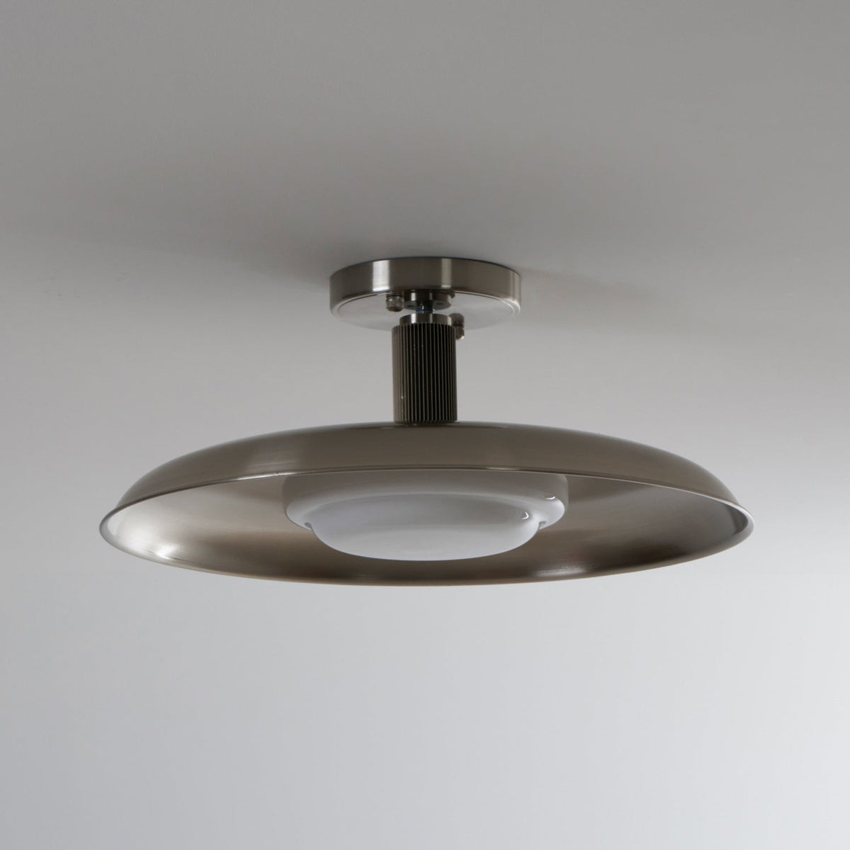 A Clérachic nickel ceiling light with its white diffuser unlit, showing the ribbed stem and brushed dish.