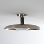 Low view of this Clérachic nickel ceiling light, unlit, with a ribbed stem and the white diffuser tucked under the dish.