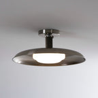 Front view of this Clérachic nickel ceiling light with a lit round diffuser beneath its brushed dish.